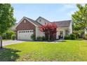 Inviting single-Gathering home with a landscaped front yard, featuring a brick accent and attached two-car garage at 3133 Cold Harbor Way, Charleston, SC 29414