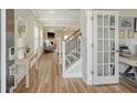 Bright foyer with hardwood floors leading to an open-concept living area and staircase at 317 Fiddleback Dr, Summerville, SC 29486