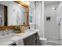 Beautiful bathroom featuring dual sinks, a framed mirror, and a tiled shower at 32 Heathwood Dr, Charleston, SC 29407