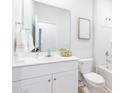 Bright bathroom featuring a white vanity, a large mirror, and a shower with a tub at 327 Pine Crest View Dr, Summerville, SC 29486
