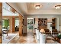 Open concept living room showcasing herringbone hardwood floors, and seamless transition to the bar and dining areas at 333 W Confederate Cir, Charleston, SC 29407