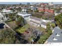 A neighborhood aerial shot featuring beautiful homes and buildings nestled among lush trees at 34 Smith St, Charleston, SC 29401