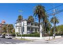 A multi-story home boasts balconies, surrounded by palms, a fenced yard, and street views at 34 Smith St, Charleston, SC 29401