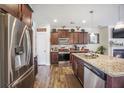 Modern kitchen featuring stainless steel appliances, granite countertops, and dark wood cabinets for ample storage at 403 Fox Sparrow Ct, Summerville, SC 29486