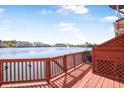 Spacious deck with wooden railings offers a tranquil waterfront view, perfect for enjoying the outdoors at 4735 Arco Ln, North Charleston, SC 29418
