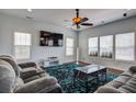 Spacious living room featuring modern furniture, a ceiling fan and lots of natural light at 500 Dolphin Dr, Summerville, SC 29485