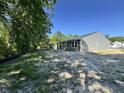 Gray-sided single-Gathering home with a small patio, set in a natural, partially wooded lot at 5031 Scow Ct, Summerville, SC 29485
