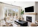 Bright living room with fireplace, large windows, and stylish furniture creates a cozy and inviting atmosphere at 508 Helmsman St, Charleston, SC 29492