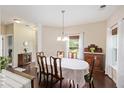 Classic dining room with dark wood floors, white walls, a chandelier, and furniture with lots of wood detail at 521 Sanders Farm Ln, Wando, SC 29492