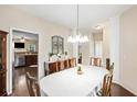 Inviting dining room featuring a pendant light fixture, dark wood floors, and convenient access to the kitchen at 521 Sanders Farm Ln, Wando, SC 29492