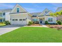 Inviting home with lush green lawn, a two-car garage, and charming curb appeal at 521 Yellow Tower Ter, Charleston, SC 29412