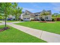 Inviting home with a well-maintained lawn, two-car garage, and sidewalk at 521 Yellow Tower Ter, Charleston, SC 29412