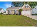Attractive single-Gathering home featuring a well-manicured front lawn and attached garage at 522 Antebellum Ln, Mount Pleasant, SC 29464