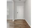 Bright entryway showcases wood-look flooring and a stylish white door with modern hardware at 525 Purple Finch Rd, Summerville, SC 29486