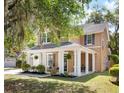 Charming home showcasing a cozy front porch, lush landscaping, and inviting curb appeal at 5471 Rising Tide, North Charleston, SC 29420