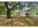 Residential property featuring a 2-car garage and scenic backyard shaded by large trees, offering peaceful privacy at 5950 Kelseys Mill Rd, Ravenel, SC 29470