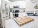 Well-equipped kitchen with stainless appliances, white cabinetry, and a subway tile backsplash at 60 Fenwick Hall Aly # 937, Johns Island, SC 29455