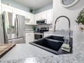 Modern kitchen features stainless steel appliances, a stylish black sink, and neutral countertops at 60 Fenwick Hall Aly # 937, Johns Island, SC 29455