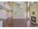 Spacious living room with hardwood floors, a cozy fireplace, and soaring ceilings at 9609 Portal Ct, Summerville, SC 29485