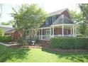 Side view of brick house with well maintained lawn and landscape and cozy outdoor patio at 100 N Gateshead Xing, Goose Creek, SC 29445