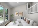 Bright living room with a vaulted ceiling, large windows, and a comfortable white sofa at 105 Brailsford Rd, Summerville, SC 29485