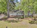 Quaint brick and siding home with well-maintained lawn and landscaping shaded by mature trees at 106 Spring Farm Pl, Summerville, SC 29485