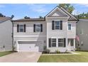 Charming two-story home with a manicured lawn, attached garage and inviting front porch with dark door at 1167 Mossy Rock Dr, Summerville, SC 29485