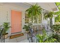 Inviting front porch with a welcoming pink door, fern plants, and decorative welcome mat at 1303 Teal Ave, Charleston, SC 29412