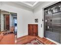 Elegant elevator entrance featuring a wooden cabinet, tile flooring, and stylish interior design elements at 136 Cooper River Dr, Mount Pleasant, SC 29464