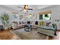 Cozy living room with a large sectional sofa, natural light, and a decorative rug over hardwood floors at 1514 Gardenia Rd, Charleston, SC 29407