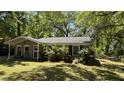 Charming brick home with manicured shrubs creating an inviting and picturesque landscape at 1521 Camp Rd, Charleston, SC 29412