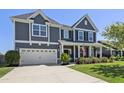 Charming two-story home with a well-maintained lawn and attached two-car garage at 1537 Fishbone Dr, Johns Island, SC 29455