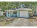 Charming light blue single story home with a one car garage and rocking chairs on the front porch at 184 Tabby Creek Cir, Summerville, SC 29486
