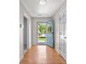 Inviting foyer with hardwood floors, featuring a bright blue front door with decorative wreath at 195 Edinburgh St, Summerville, SC 29483