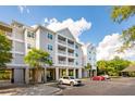 Well-maintained condo complex with multiple balconies, parking, and verdant landscaping at 1984 Folly Rd # A103, Charleston, SC 29412