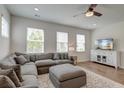 Cozy living room featuring a sectional sofa, plush ottoman, and a TV, perfect for relaxation and entertainment at 207 Winding River Dr, Johns Island, SC 29455