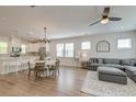 Open-concept living space with stylish decor, a modern ceiling fan, and hardwood flooring at 207 Winding River Dr, Johns Island, SC 29455