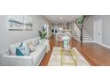 Spacious living room flows into a dining area and kitchen with neutral decor and hardwood floors at 2130 Weaver St, Charleston, SC 29403