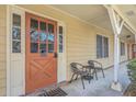 Inviting entryway with orange door, glass panels, chairs, and views of the exterior at 2150 Spoleto Ln # B-11, North Charleston, SC 29406