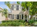 Inviting home exterior with black shutters, manicured hedges, and a classic entryway at 23 Savage St, Charleston, SC 29401