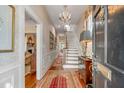 Elegant foyer with a chandelier, hardwood floors, and a grand staircase at 23 Savage St, Charleston, SC 29401