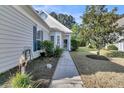 Landscaped front yard and walkway lead to a welcoming entrance, creating a pleasant curb appeal at 239 Sea Lavender Ln, Summerville, SC 29486