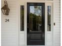 Close-up of the front door showcasing its sleek design, sidelights, and lantern creating a welcoming entrance to the property at 24 Chalmers St, Charleston, SC 29401