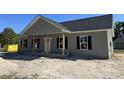 Inviting one-story home with a covered front porch and classic black shutters at 250 Dandelion Ct, Round O, SC 29474