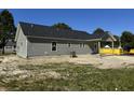 Back exterior of a new construction single-story home featuring a covered porch at 250 Dandelion Ct, Round O, SC 29474