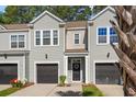 Townhome with a front yard, garage, and walkway leading to the front door at 2505 Stadium Dr, North Charleston, SC 29406