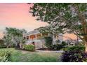 Beautiful low angle exterior view of the house, showcasing its lush landscaping and multiple stories at 2640 Crooked Stick Ln, Mount Pleasant, SC 29466