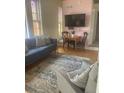 Comfortable living space with a plush sofa, accent chair, and a dining area set against stained glass windows at 309 Meeting St # 8, Charleston, SC 29401