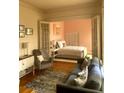 Cozy living room featuring hardwood floors, neutral furniture, and open access to the adjacent bedroom at 309 Meeting St # 8, Charleston, SC 29401