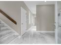 Entryway featuring marble flooring, a wooden banister and staircase leading upstairs at 3635 Pompano Ct, Seabrook Island, SC 29455